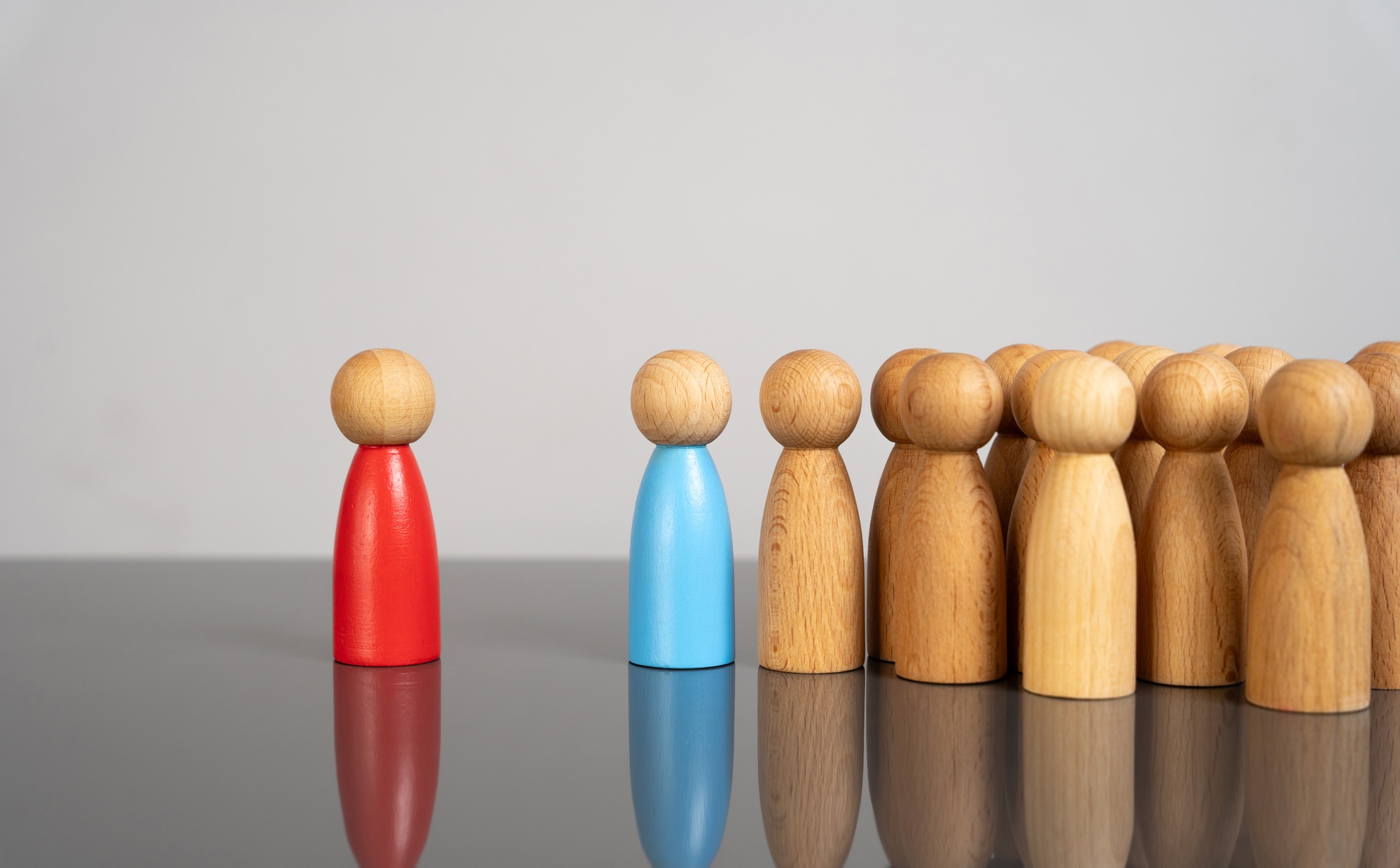 The blue man leads the people against the red man. The concept of supporting the majority against